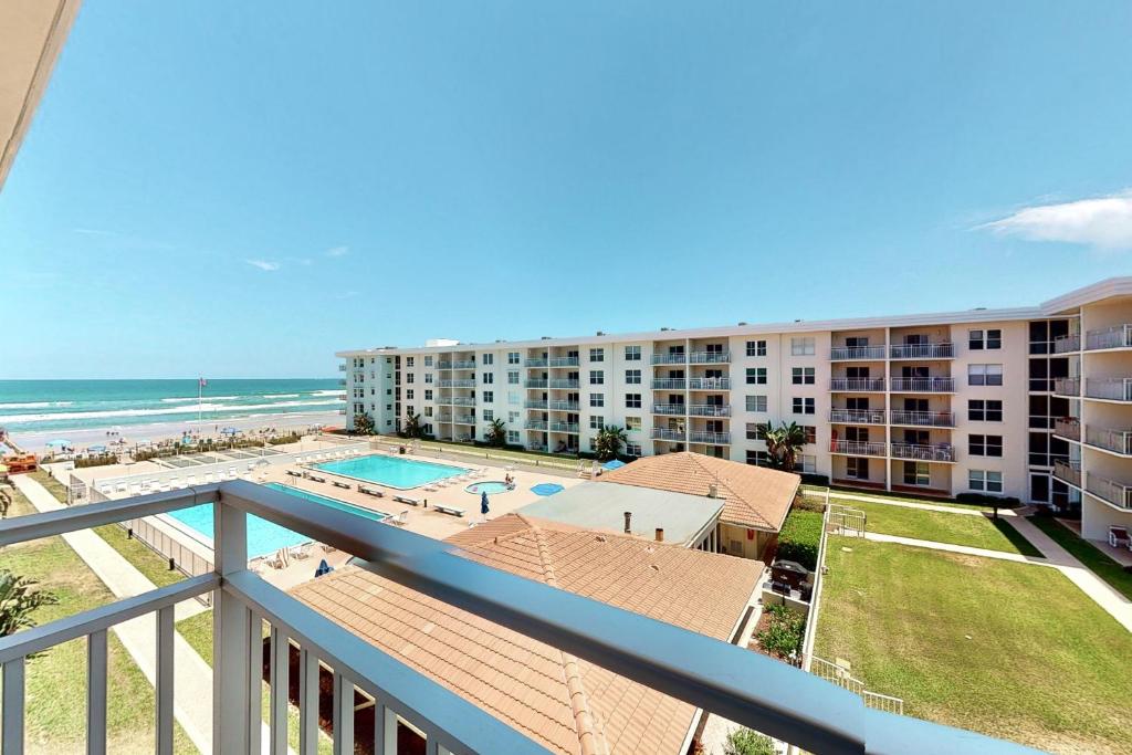 a view of the beach from the balcony of a resort at Wait n' Sea in New Smyrna Beach