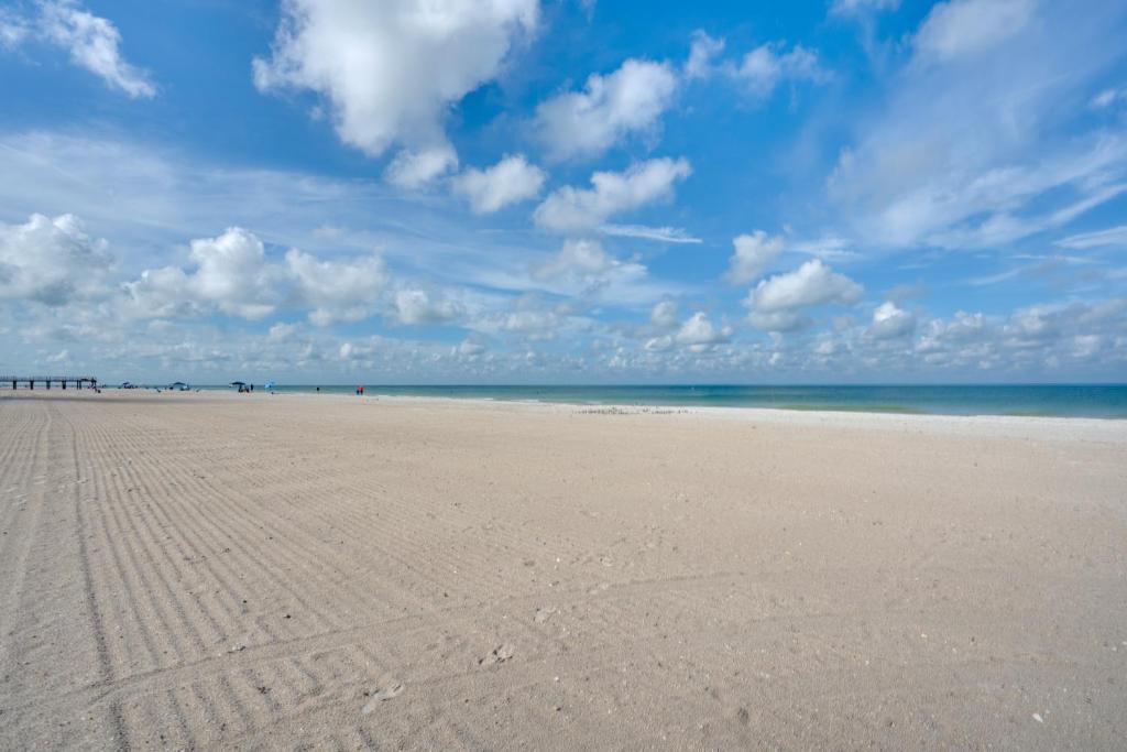 a sandy beach with footprints in the sand at Walk to Redington Beach Renovated Duplex with Patio in St Pete Beach