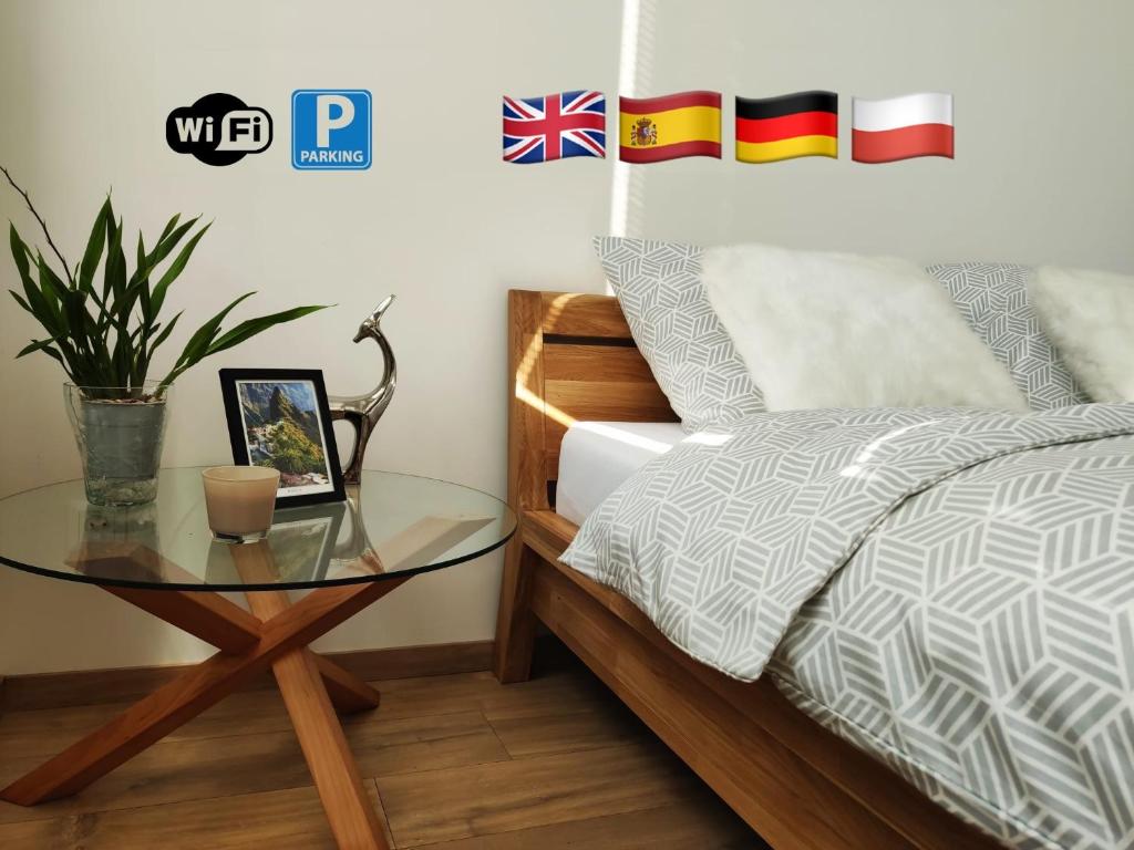 a bedroom with a bed and a glass table at Brand New Place in the City Centre in Žilina