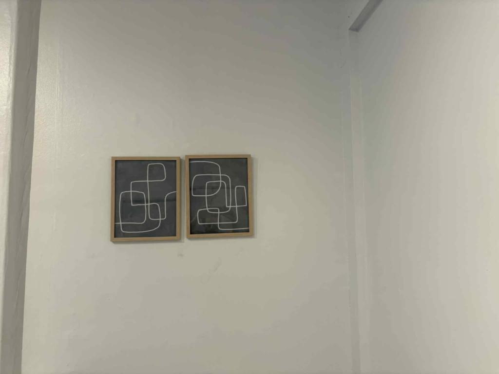 two pieces of art on a white wall at Spacious apartment in dowtown Montreal in Montréal