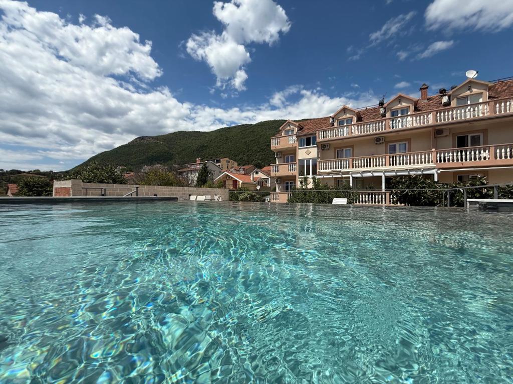 a large pool of water in front of a building at B&B Guest House Vasiljevic in Herceg-Novi