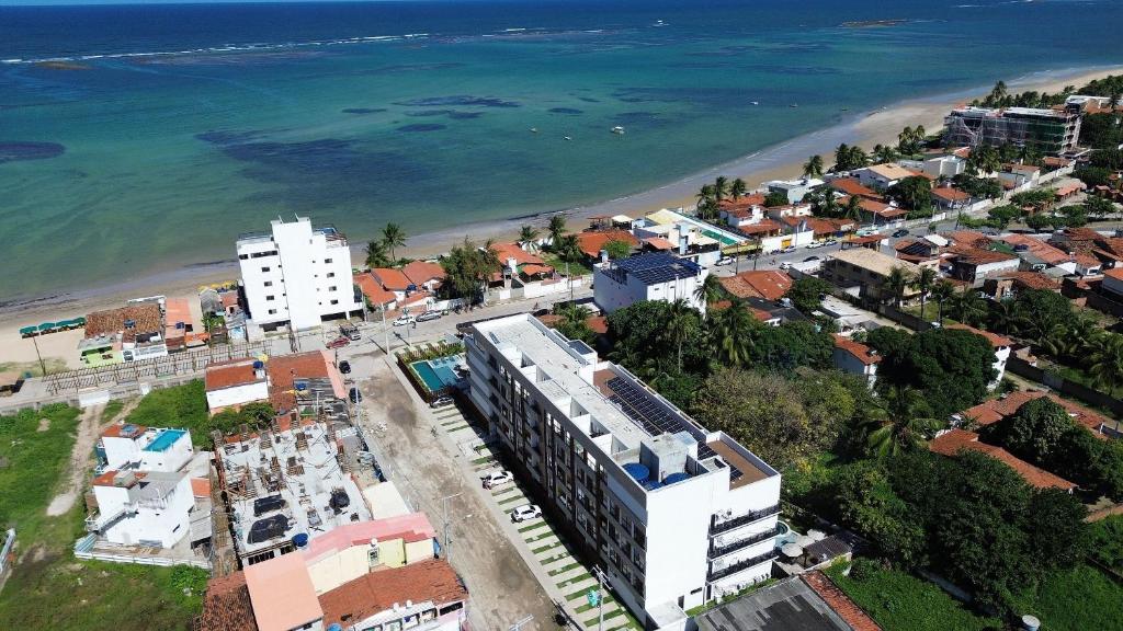 an aerial view of a city and the beach at Maré Alta Beach Hall - Praia de Tamandaré in Praia dos Carneiros