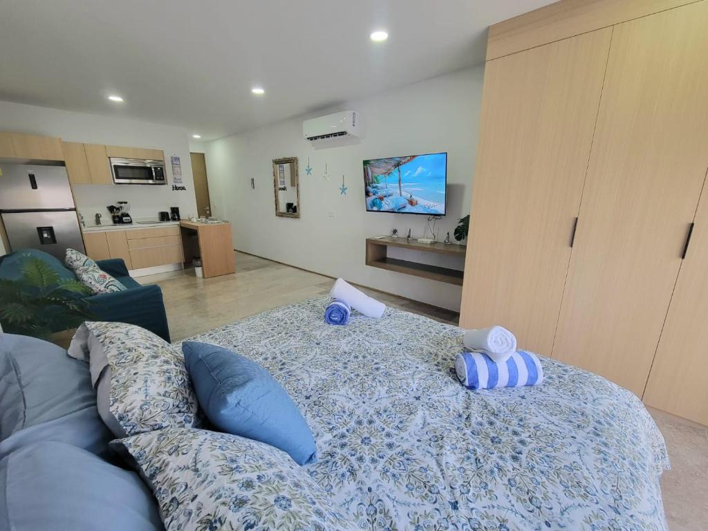 a living room with a bed and a couch at Live Playa Beach, Luxury & 5th Av at your doorstep in Playa del Carmen