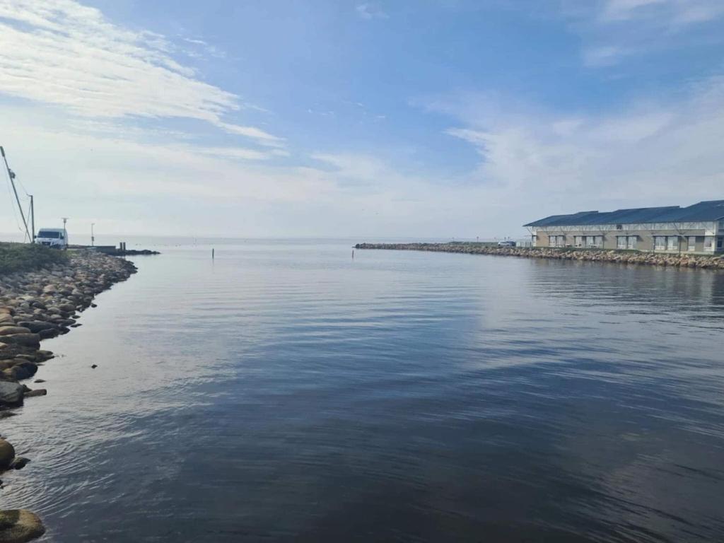 a view of a body of water with buildings in the background at Charming Retreat in Ringkobing in Ringkøbing