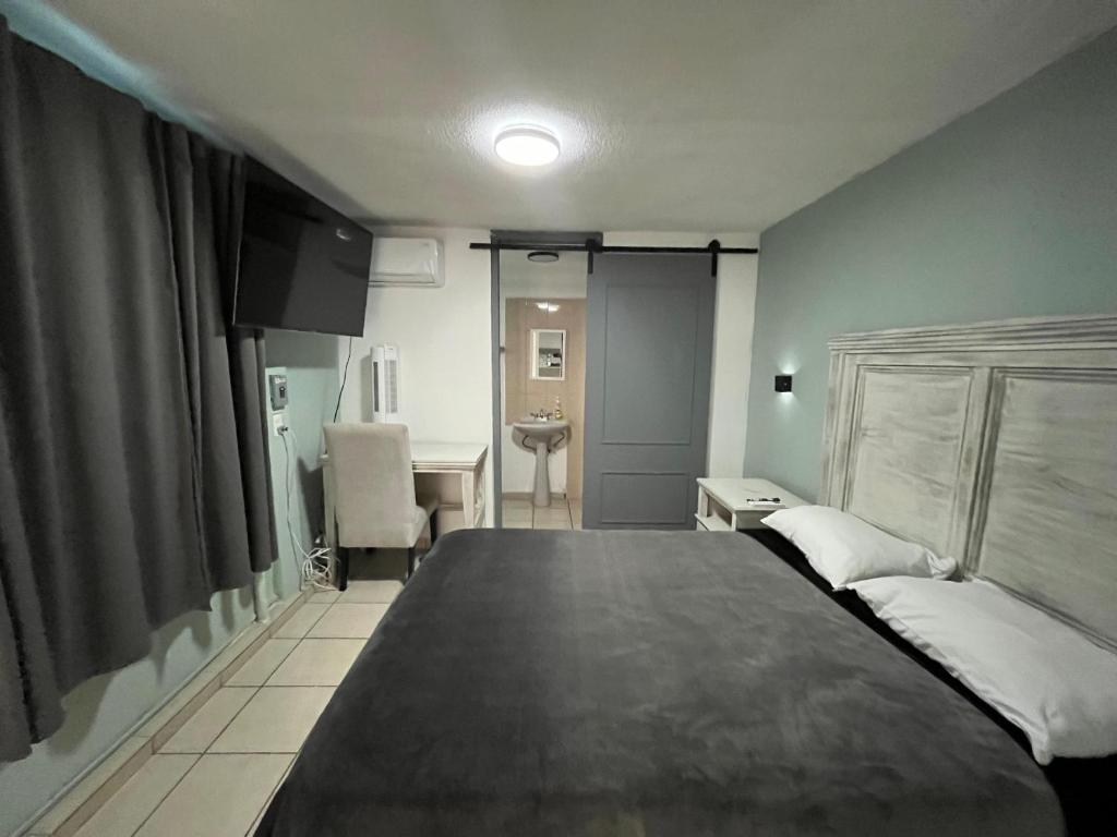 a bedroom with a large bed and a desk at 9 VENATOR House Boutique in Miravalle