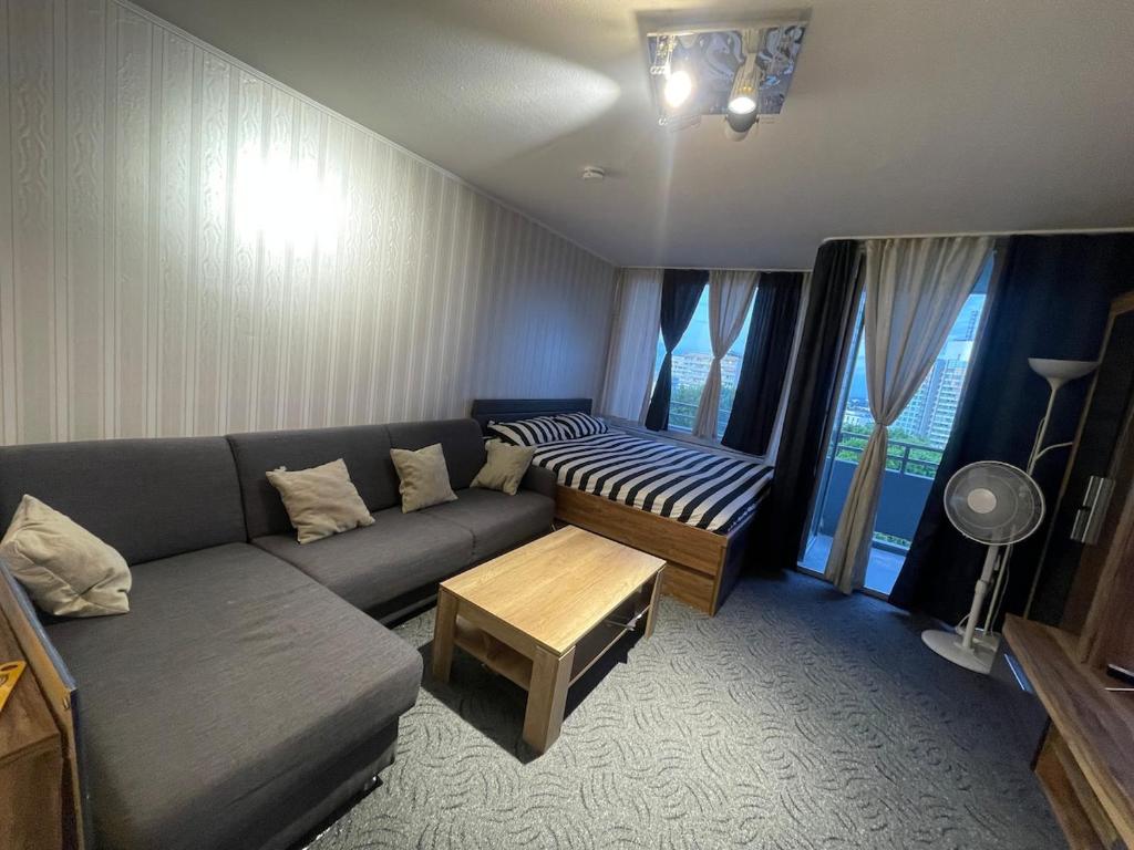 a living room with a couch and a table at Panorama building in Eschborn