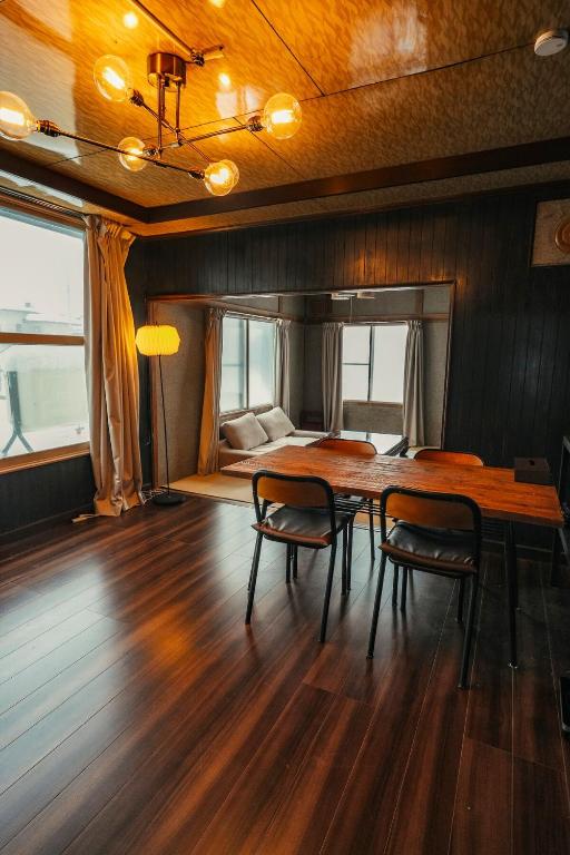 a dining room with a table and two chairs at Cabin Build Take - 竹 in Biei