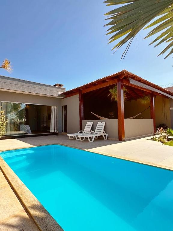 a villa with a swimming pool and a house at Rancho Palmeira Diversão e Descanso em um Só Lugar in Formosa