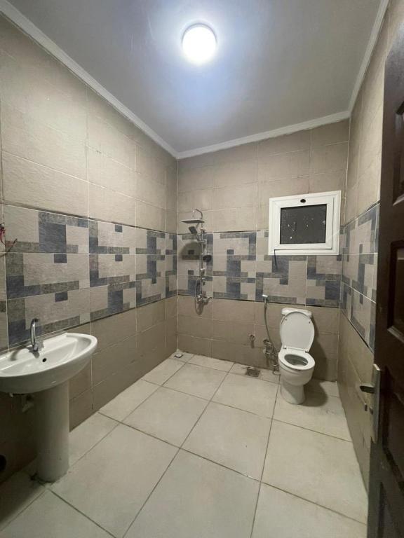 a bathroom with a toilet and a sink at الاسكندريه كينج مريوط in King Mariout