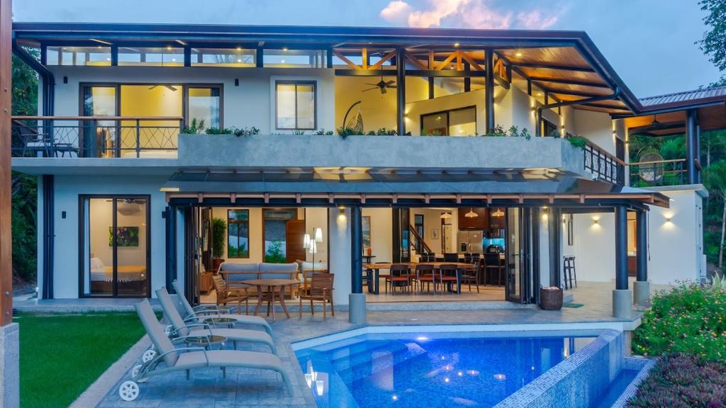 a house with a pool in front of it at Villa Hermanos Luxury Home with Ocean View in Sámara