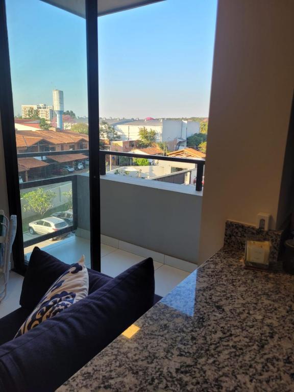 a living room with a couch and a large window at insignia5 in Luque