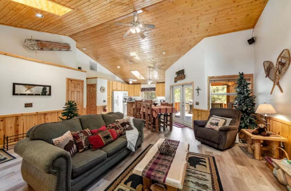 a living room with a couch and a table at Wren's Nest and Hot-Tub, Games with Best Location! in Big Bear Lake