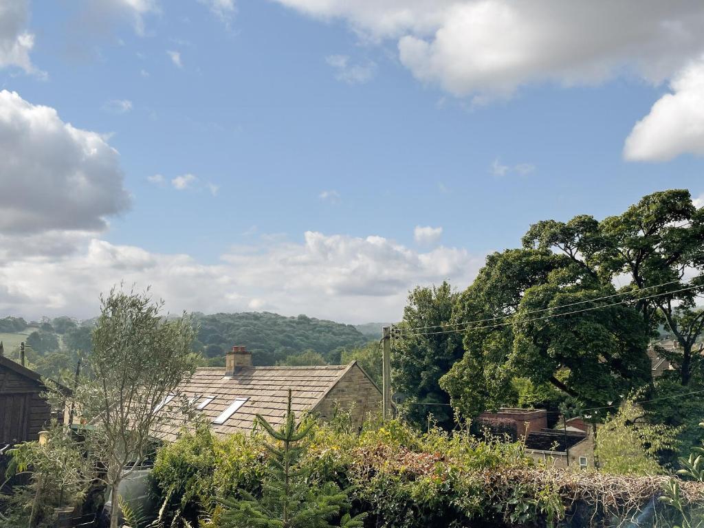 a view of roofs of houses and trees at Yew Tree Cottage in Old Brampton