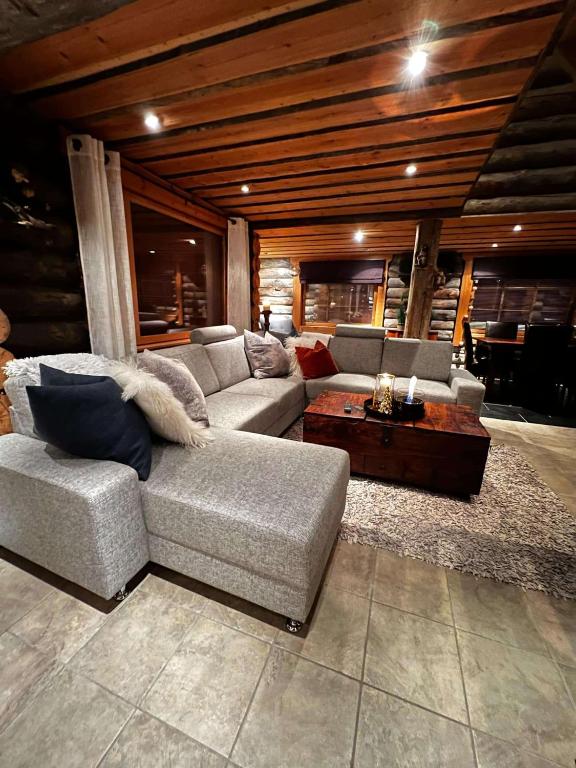 a living room with a couch and a table at Exclusive Cabin with lovly Northern Lights Views in Kilpisjärvi