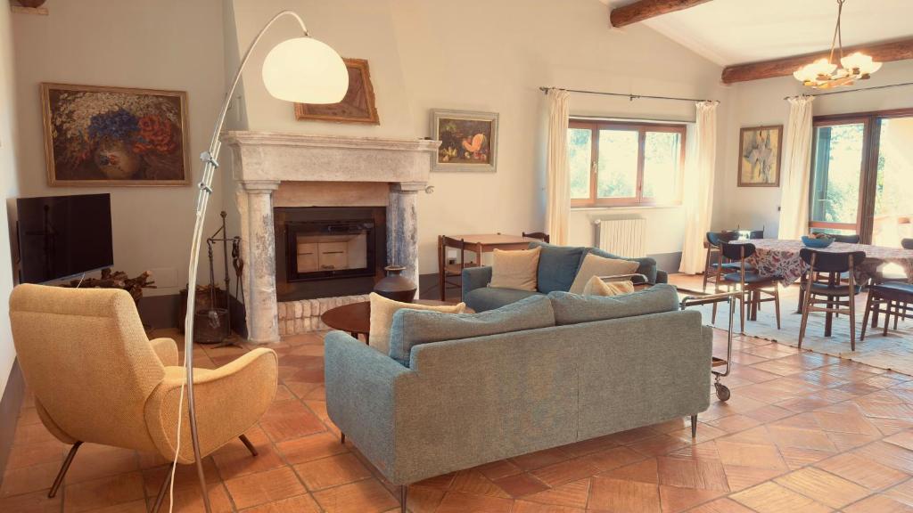 a living room with two couches and a fireplace at Pool Villa With Animals Near Sutri in Sutri