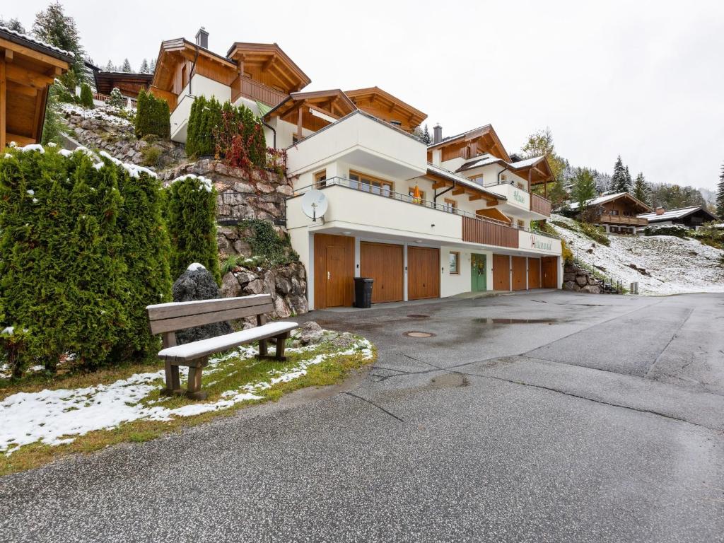 a bench sitting in front of a building at Chalet in Saalbach near Ski Lift in Saalbach-Hinterglemm