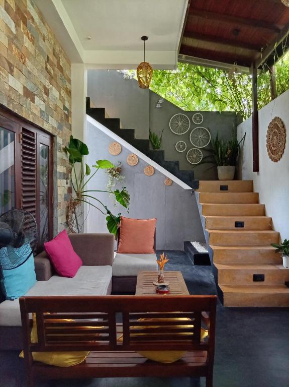 a living room with a couch and a staircase at Villa D40 in Weligama
