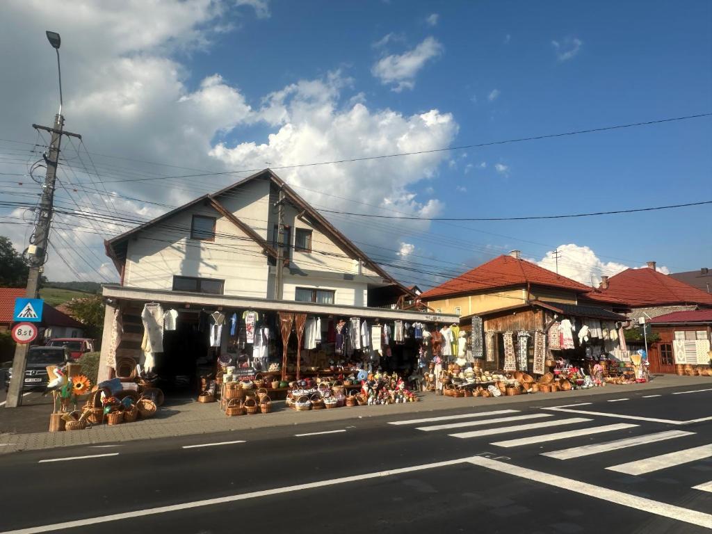 a store on the side of a street with a building at Korond Mako panzio in Corund