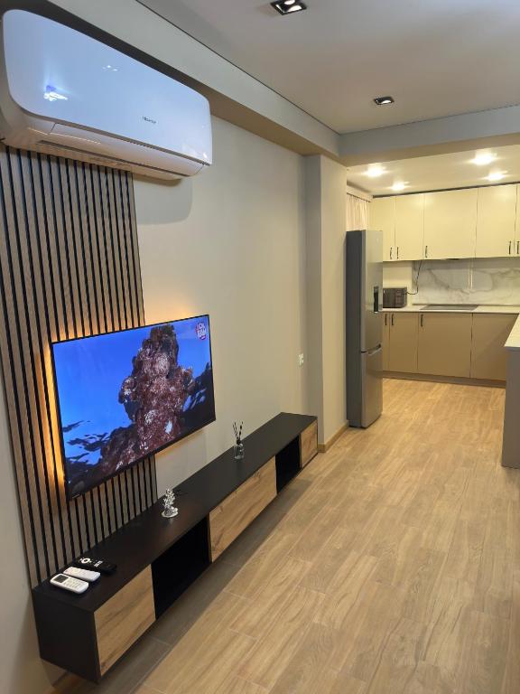 a living room with a flat screen tv on a wall at Suvorov96 in Yerevan