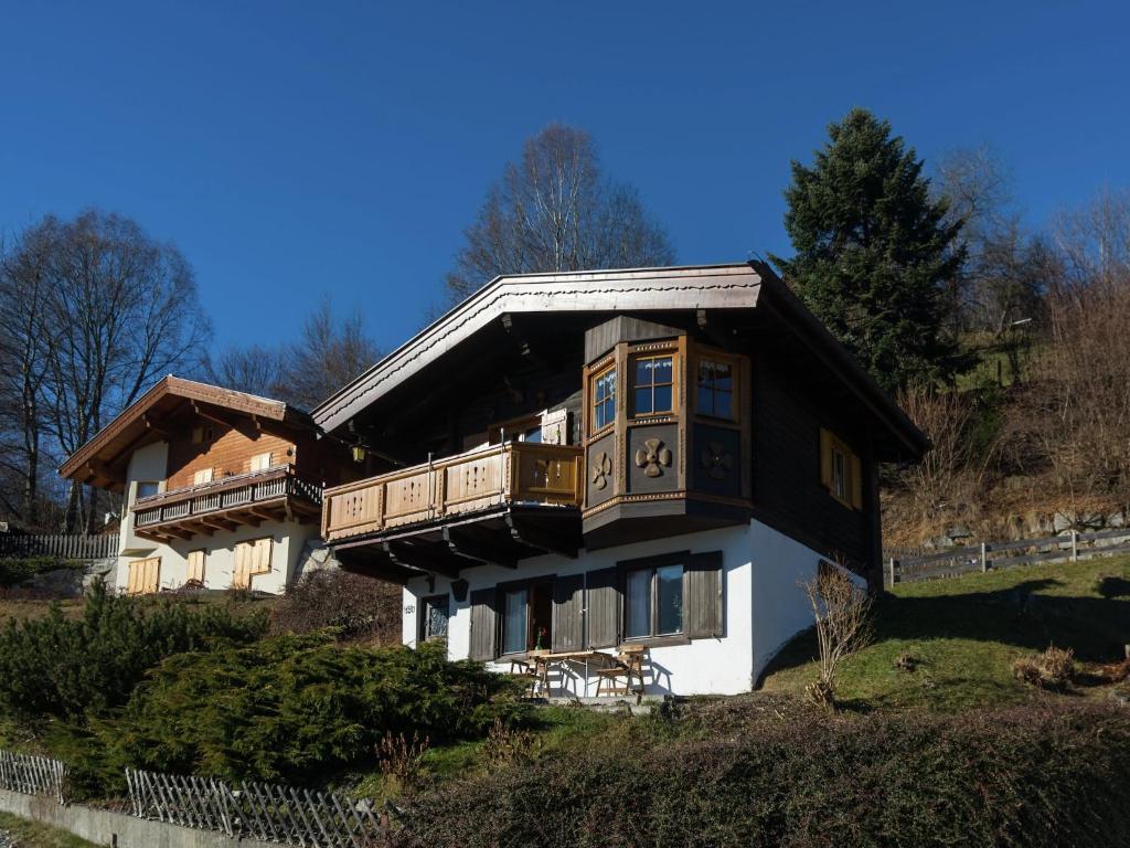 a large house with a balcony on a hill at Chalet on the slopes in Piesendorf