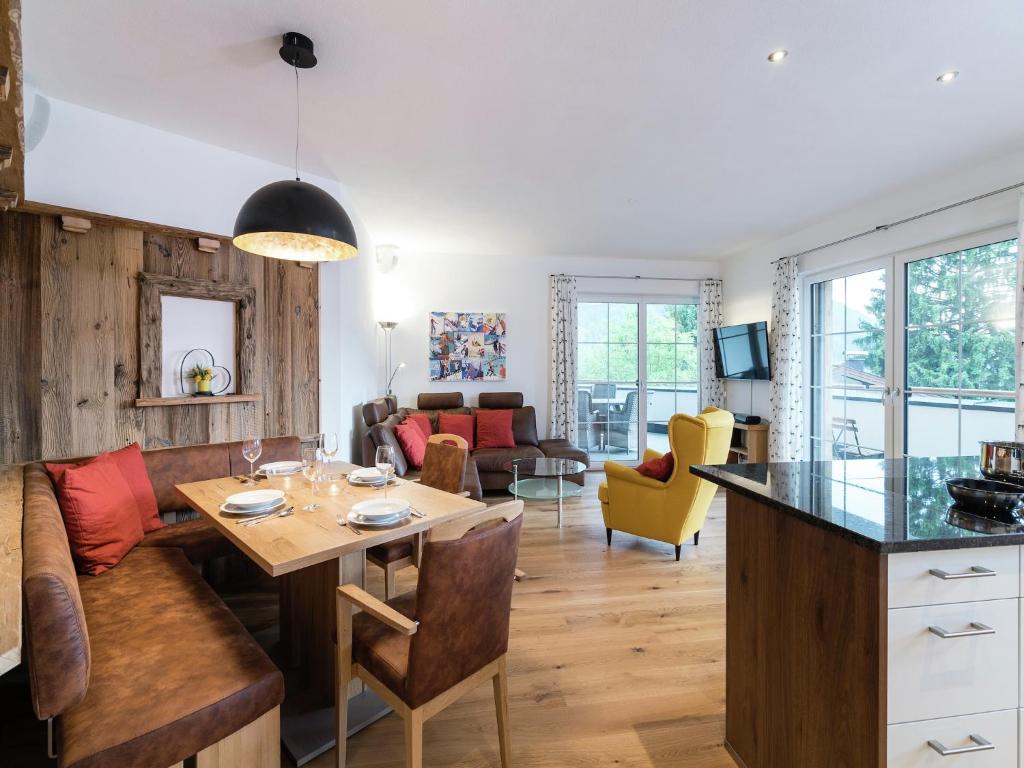 a kitchen and living room with a table and chairs at Chalet in Sankt Johann near Ski Slopes in Alpendorf