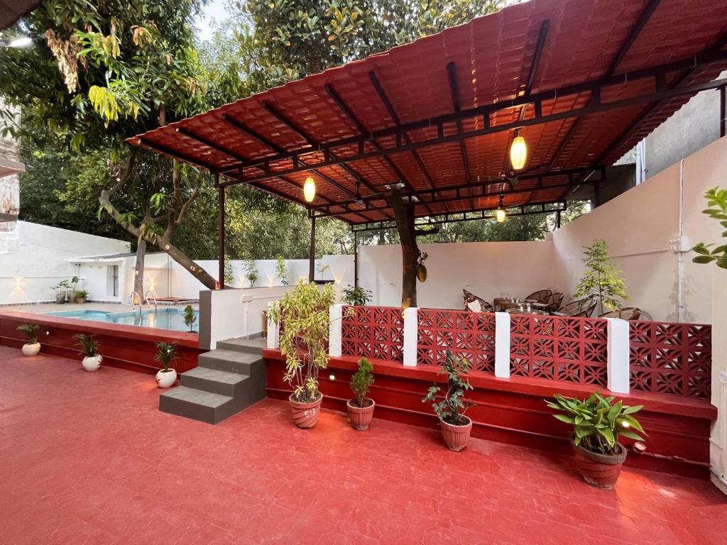 a patio with potted plants and a pool at L'EDELWEISS Heritage House in Pondicherry