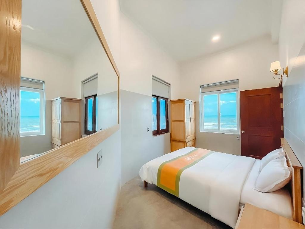 Ένα ή περισσότερα κρεβάτια σε δωμάτιο στο Bay View Beach Villas Mũi Né