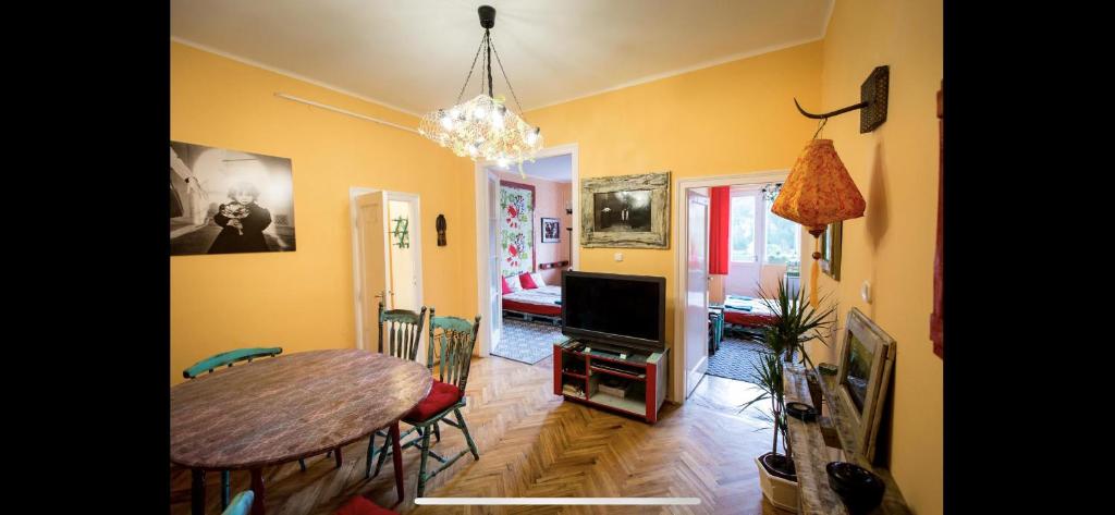 a living room with a table and a dining room at Best Location cosy Art flat in Budapest