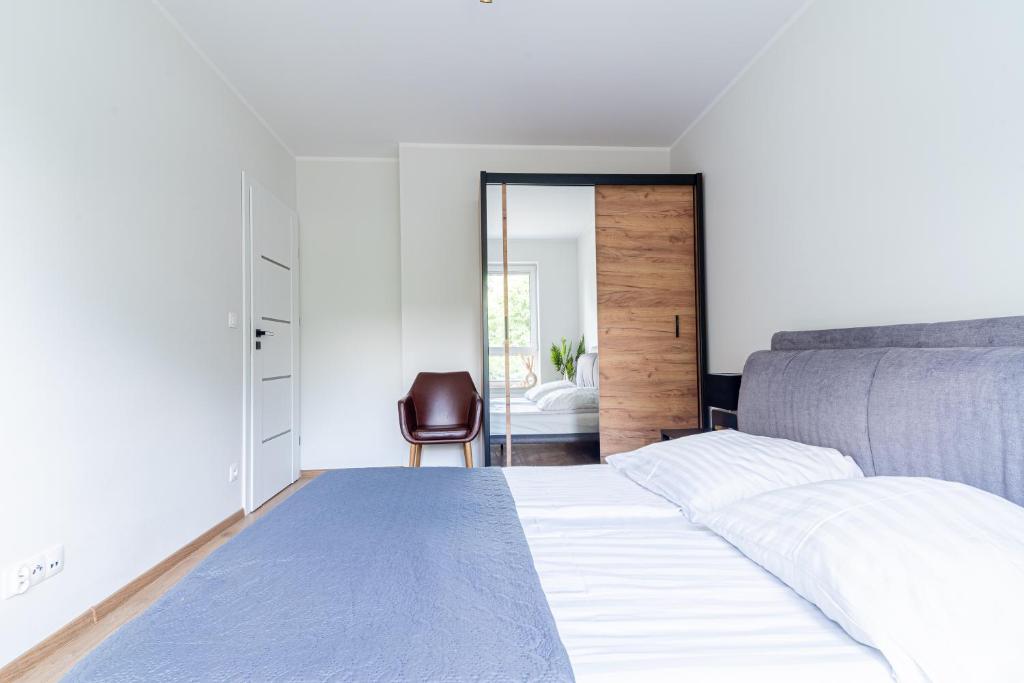 Postel nebo postele na pokoji v ubytování Apartament MK Sosnowskiego 9