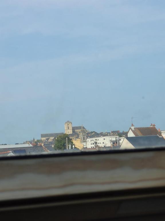 a view of a city from a window at Chambre chez Manue in Le Mans