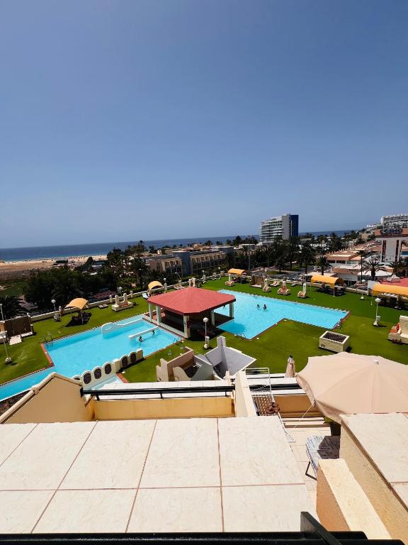 a view of a large pool with a gazebo at Las Mareas Sea View Terrace 3 min to Beach in Morro del Jable