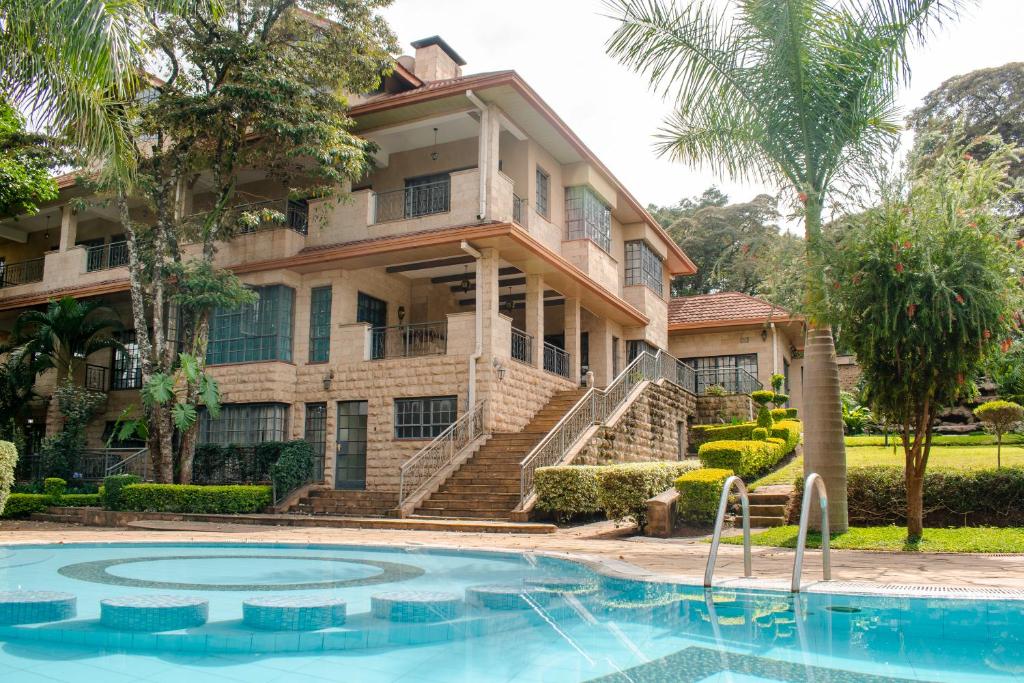 a house with a swimming pool in front of it at selvasara suites in Nairobi