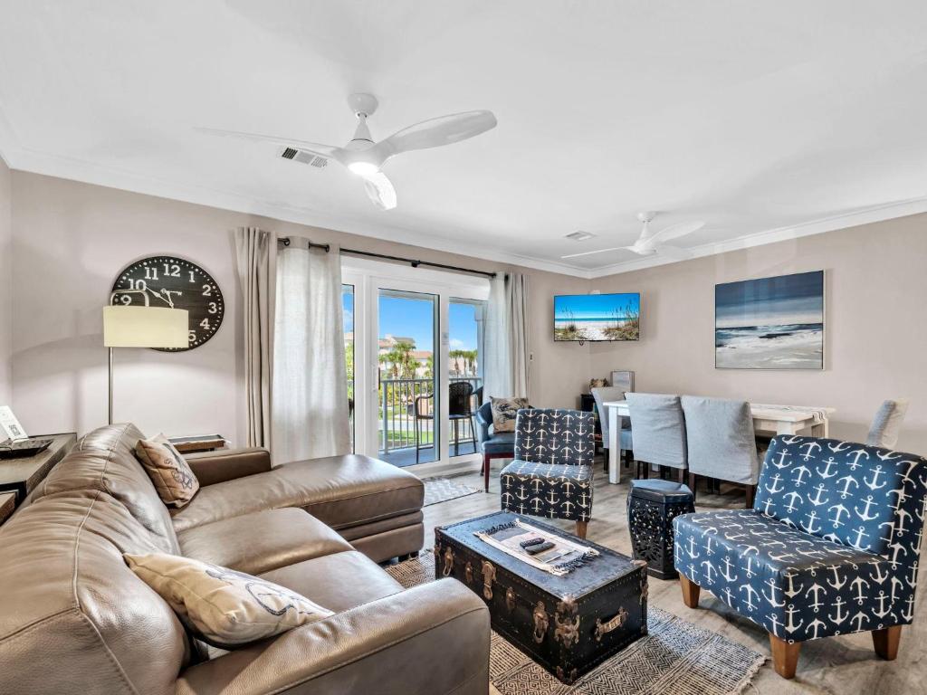 a living room with a couch and chairs at Beachside Villas 122- Sun for the Roses in Santa Rosa Beach