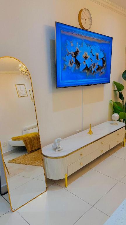 a room with a table and a clock on the wall at Beautiful Luxury Apartment in Johannesburg