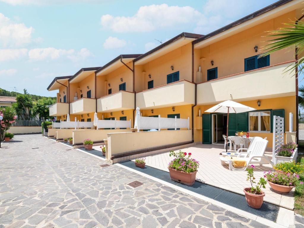 an exterior view of a hotel with a patio at Belvilla by OYO Conca degli Dei con giardino in Paestum