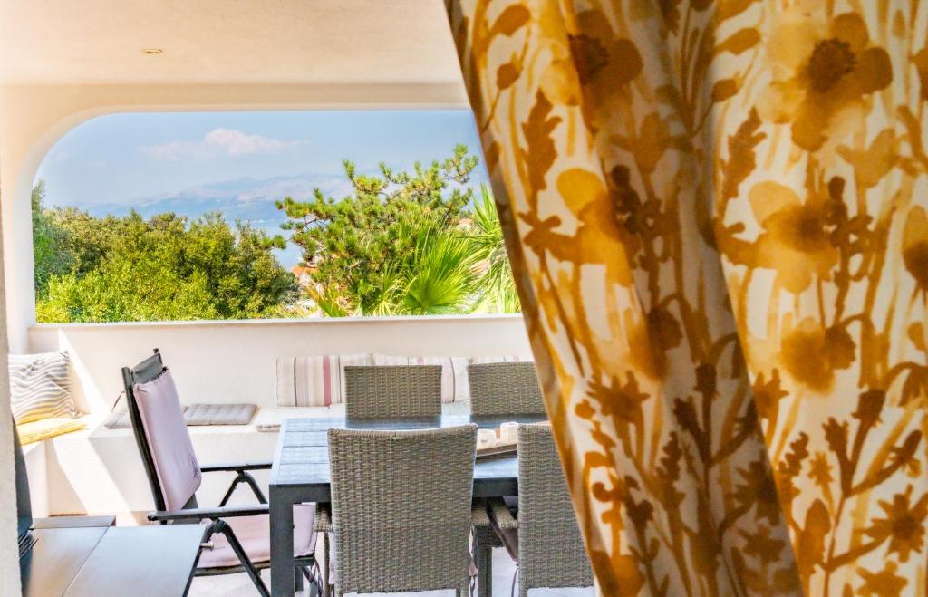 a view from the balcony of a house with a table and chairs at Apartments Marijin Dvor in Splitska
