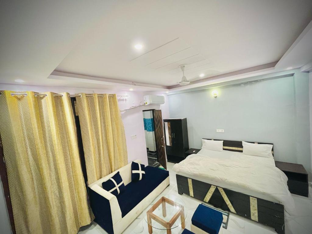 a bedroom with a bed and a chair at Hotel regal garden in Faridabad