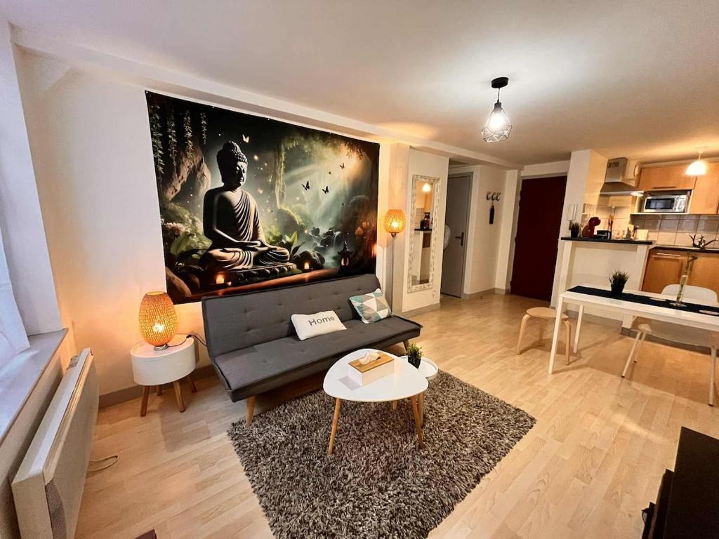 a living room with a large painting on the wall at Cocon Zen en plein Cœur historique de Rouen in Rouen