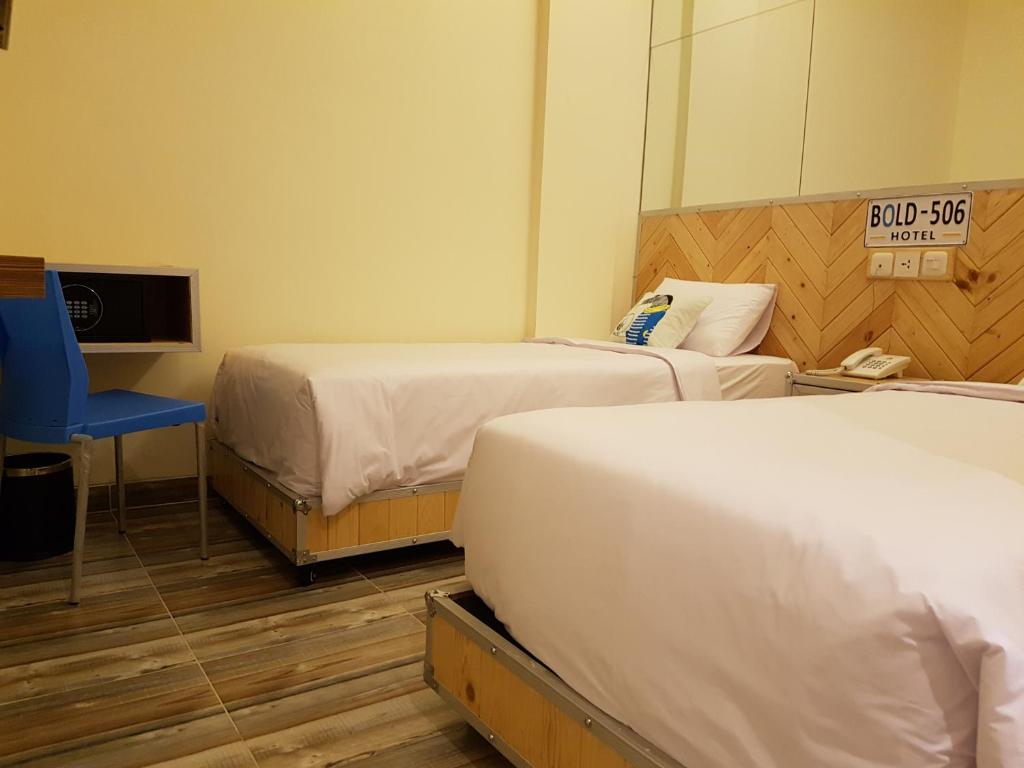 Postel nebo postele na pokoji v ubytování Bold Hotel Jakarta