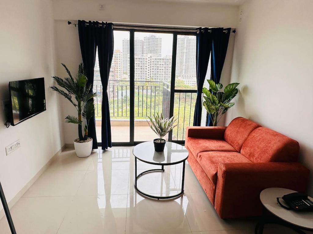 a living room with a couch and a table with plants at Joy Pvt 1Bhk in Amanora Most Awarded Township in Pune