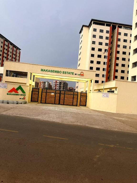 a large building with amanagement centre in front of buildings at Home Haven - 1 Bedroom Apartment in Kisumu