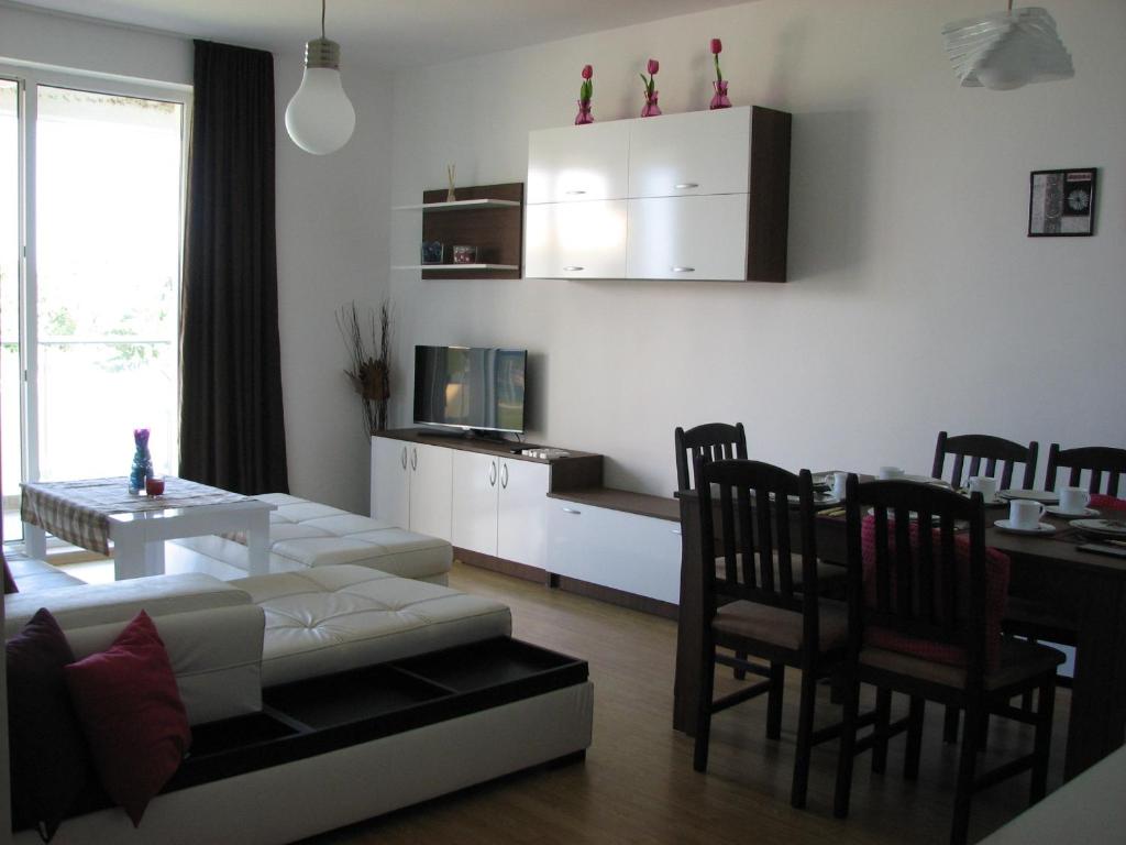 a living room with a couch and a table and chairs at Two-Bedroom Apartment Donika in Tsarevo