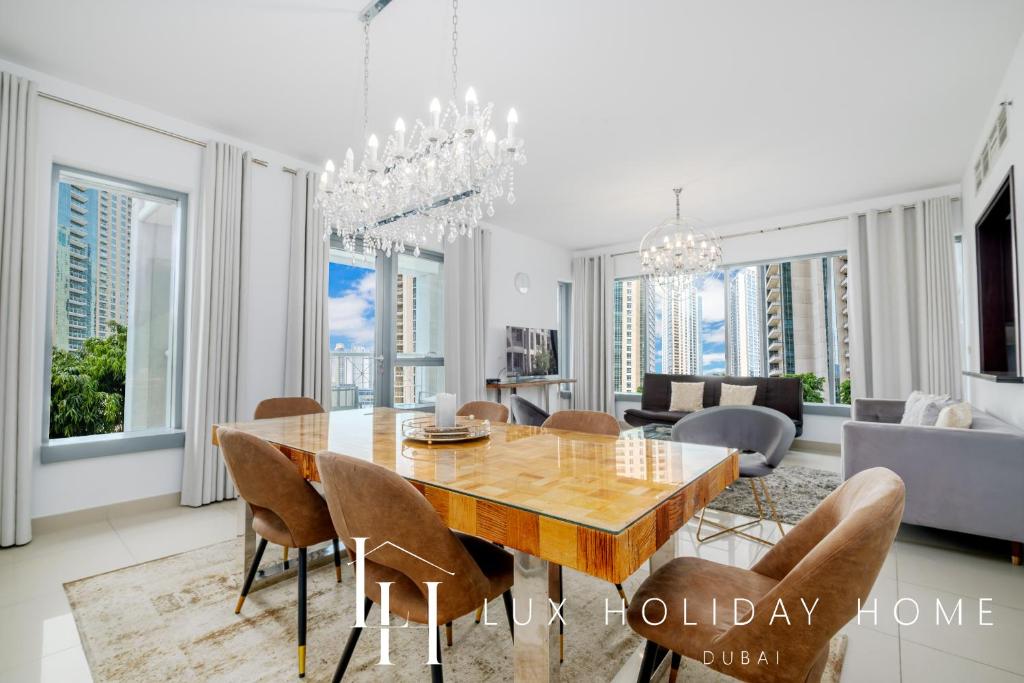 a dining room with a table and chairs at LUX - The Downtown Blvd Suite in Dubai