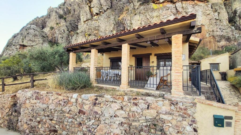 a building on the side of a mountain at Casa Rural Mar de Encinas in Cabañas del Castillo