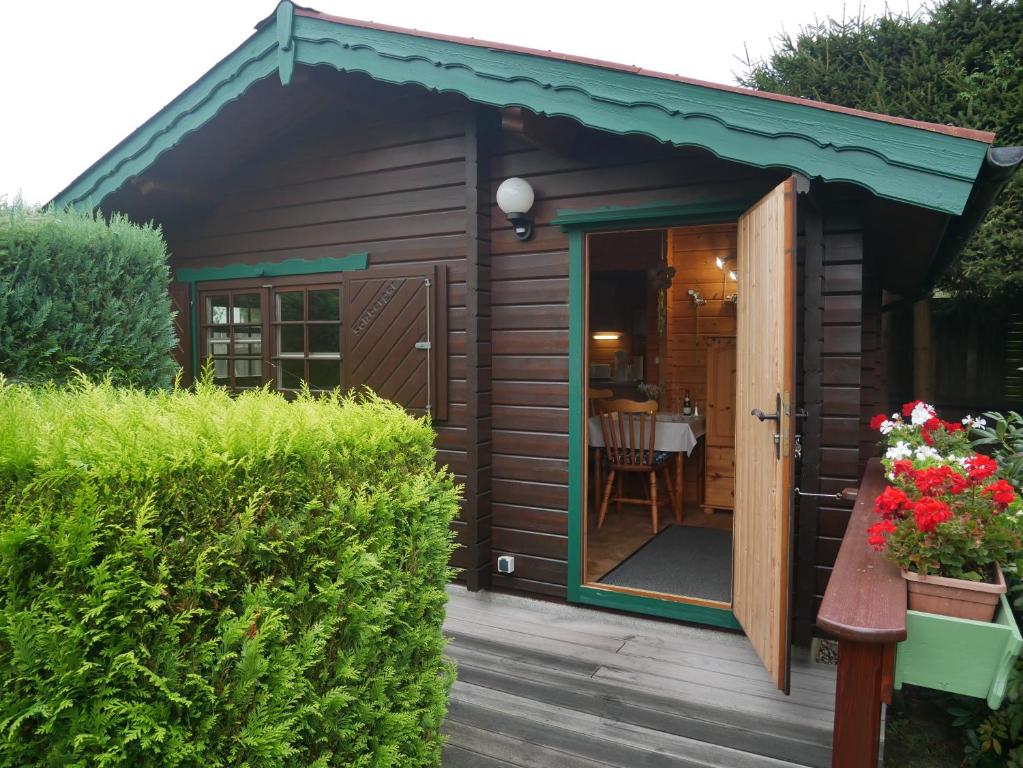a small shed with a door and a patio at Bungalow Brandl in Zinnowitz