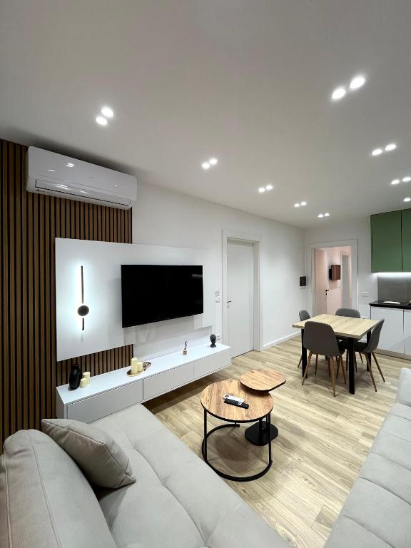 a living room with a white couch and a table at Mimi's Apartment in Durrës