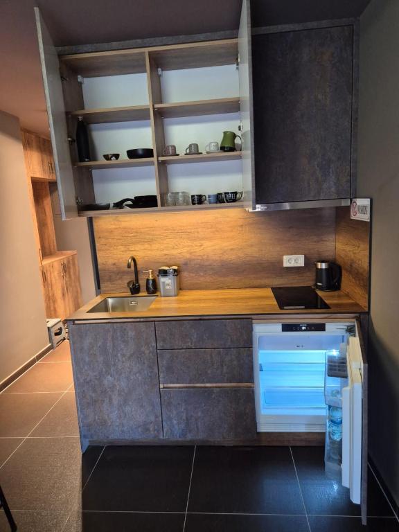 a small kitchen with a sink and a stove at Meli Deluxe in Prizren