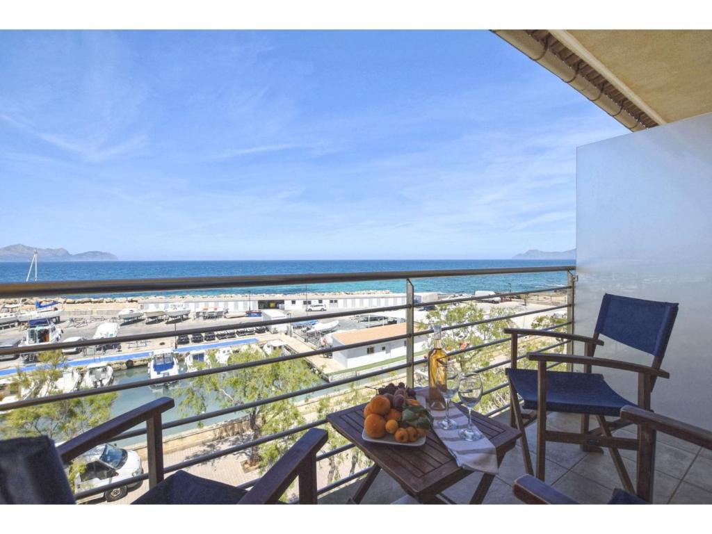 a balcony with a table and chairs and a view of the beach at Harborfront Escape in Mallorca in Can Picafort