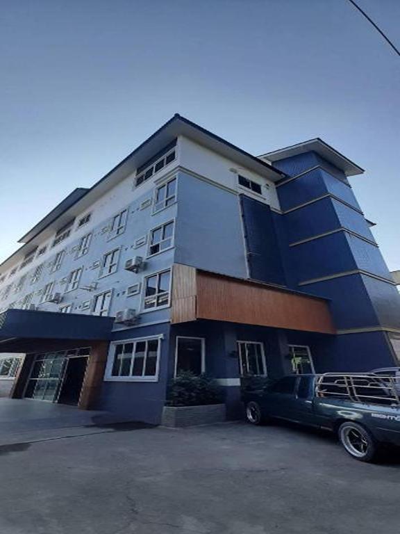 a building with a car parked in front of it at Eastan Golf View ChiangMai in Chiang Mai