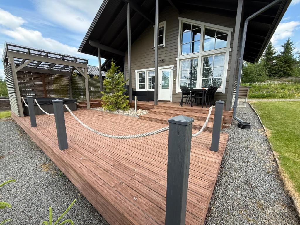 a wooden deck in front of a house at Villa Hile - 8 hengen mökki, rauhallinen sijainti Himoksen ytimessä in Jämsä